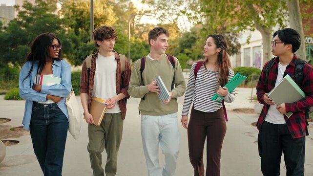 Multicultural friends walking together, enjoying student life in modern university campus