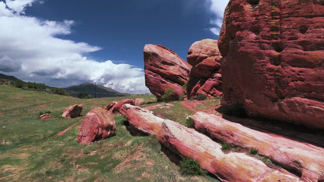 Hiking trails through Red Rocks Ken Caryl Valley Ranch neighborhood homes North Valley Meadow Ranch Front Range Denver Colorado aerial drone Rocky Mountains foothills cloudy summer morning forward pan