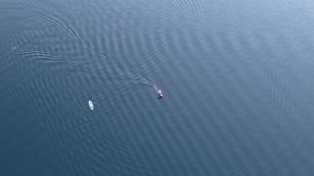 drone shot of someone falling off of a foilboard into the water