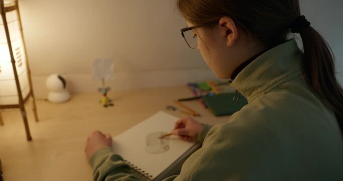 Girl Draw Pictures With Pencil on Desk Table in Bedroom at Home. 4K 10-bit