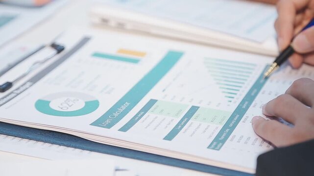 Close up of businesswomen or accountant using calculator calculate while working analytic business report on the workplace, Planning financial and accounting concept.