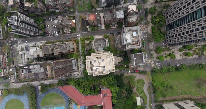 Top down aerial view of Taipei, the vibrant capital city of Taiwan, showing streets, parks and modern skyscrapers in the Xinyi District on a sunny day.