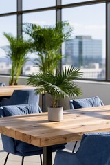 Fototapeta premium Modern office table with small potted palm for workspace background and biophilic sustainable interior design