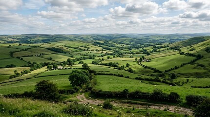 Obraz premium A sweeping view of green patchwork hills, hedgerows, grazing sheep, and scattered farmhouses under a cloud-filled sky suits rural travel and nature campaigns.