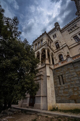 Obraz premium Historic facade of Miramare Castle with moody evening atmosphere near Trieste, Italy. Elegant nineteenth-century architecture by the Adriatic Sea.
