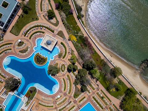 Top down aerial view of luxury beachfront resort hotel with pools