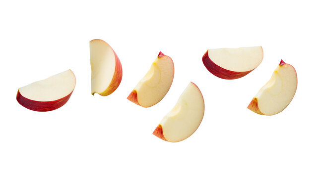 Fresh red apple slices, scattered and isolated on transparent background