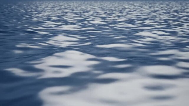 Serene blue ocean water ripples with soft sunlight reflections on a calm surface