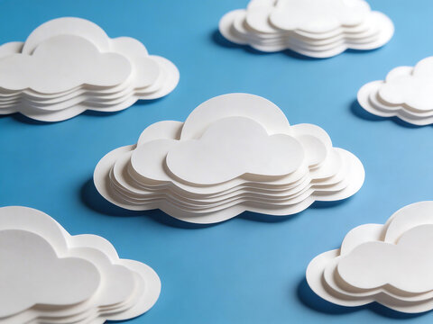 Stacks of paper clouds on blue background