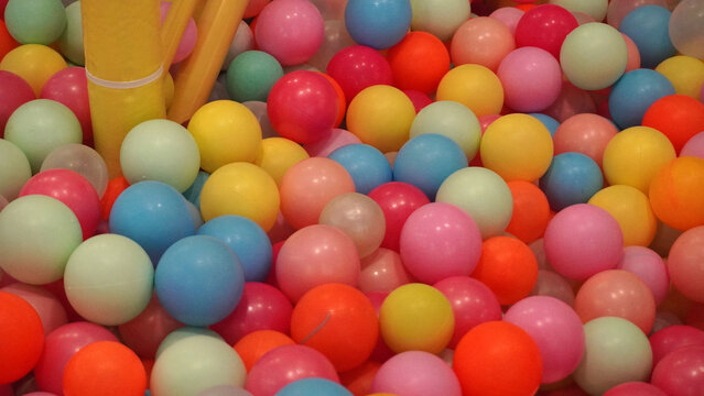 Colorful plastic balls filling a children's ball pit.