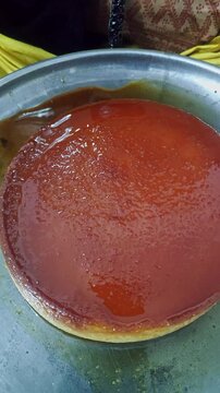 Closeup view of caramel flan dessert showing smooth texture and glossy caramel topping