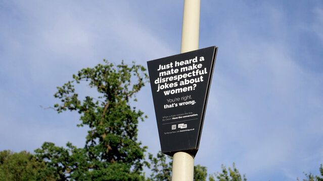 Leicester, England, UK - 28 June 2026: Social awareness campaign sign on street post, anti discrimination public notice about respect for women, educational billboard against disrespectful jokes
