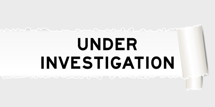 Ripped gray paper background that have word under investigation under torn part
