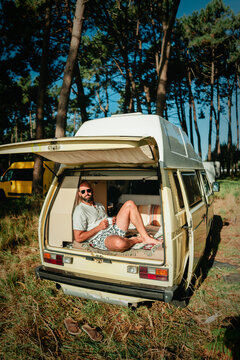 Man Relaxing in Open Vintage Campervan in Pine Forest &ndash; Van Life Lifestyle