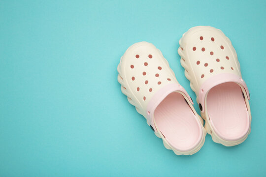 Mykolaiv, Ukraine - April 25, 2026: Couple of white Crocs sandals on light blue background.