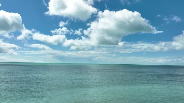 4k drone video flight over ocean, sea. Close to the water. Calm Sea Background for Travel, Vacation, and Meditation.