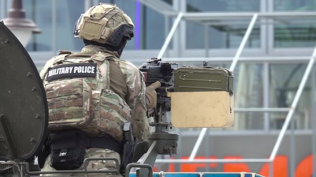 Special Forces Soldier Operating Mounted Machine Gun on Armored Military Vehicle During Tactical Combat Training Exercise