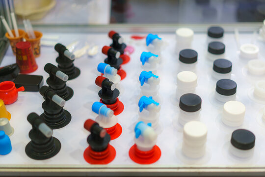 Collection of diverse plastic bottle caps and nozzles in display.