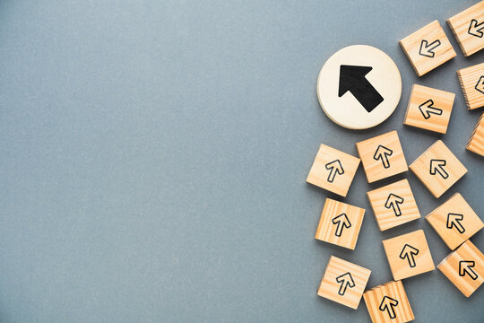 Strategic Alignment and Unified Direction Concept with Wooden Arrow Blocks
