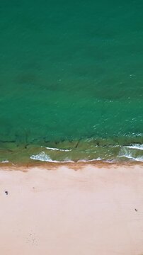 Top Down Aerial View of Waves Crashing on Sandy Beach