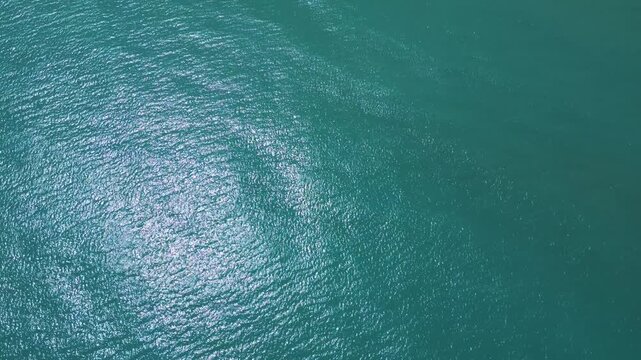 Aerial Top Down View of Sparkling Turquoise Sea Water Surface