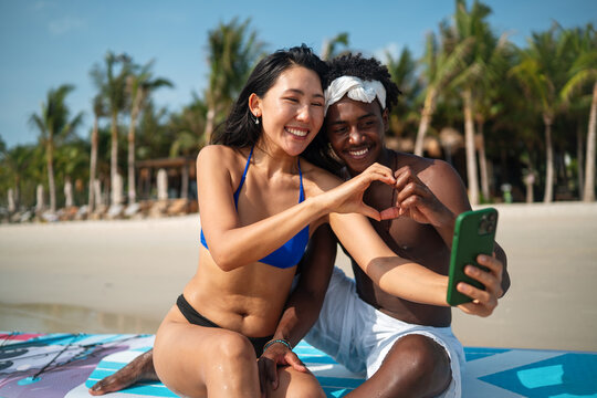 Beautiful diverse couple enjoying in good mood on the beach. Lifestyle love dating vacation concept