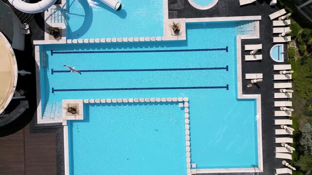 Top Down Aerial View of Luxury Resort Swimming Pool and Sunbeds