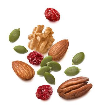 Walnut, pecan and almond nuts, pumpkin seeds, cranberry isolated on white background. Real photography