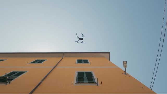 Professional drone taking off low angle shot, urban building background