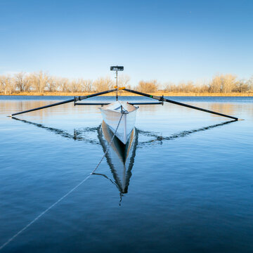 Coastal rowing shell on a calm lake in Colorado