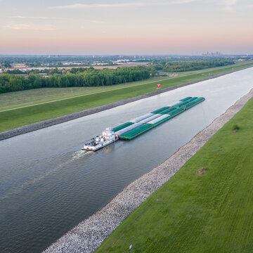 towboat with barges on Chain of Rocks Canal of Mississippi River above St Louis - aerial view
