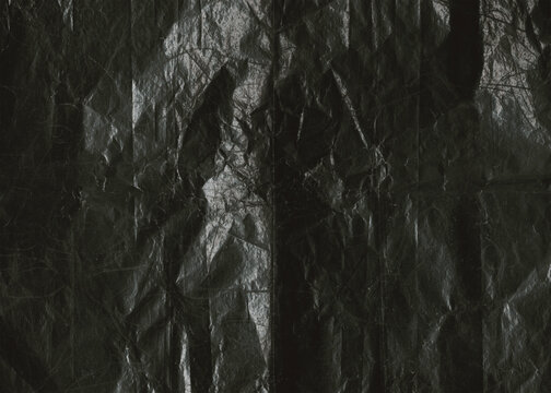 Black wrinkled plastic surface texture background.