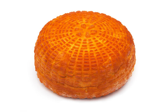 One piece of fresh homemade smoked cheese on a white background. Side view.