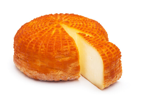 Piece of fresh homemade smoked cheese with a slice on a white background. Side view.