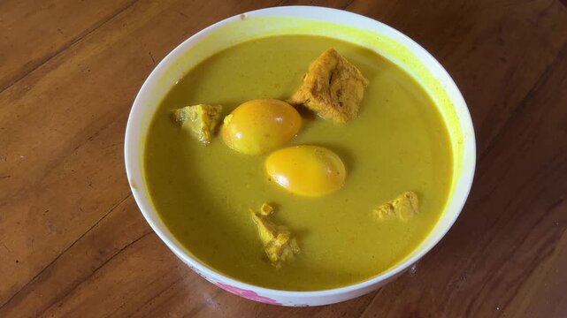 4K Top View Video of Indonesian Gulai Telur Tahu Tempe Coconut Curry Steaming in Bowl for Asian Cuisine and Food Documentary Footage