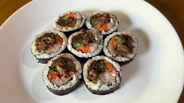 4K Top View Video of Korean Bulgogi Kimbap Rice Rolls with Beef and Vegetables for Korean Cuisine and Food Documentary Footage