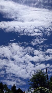 Dramatic clouds moving under clear blue sky 4k video 