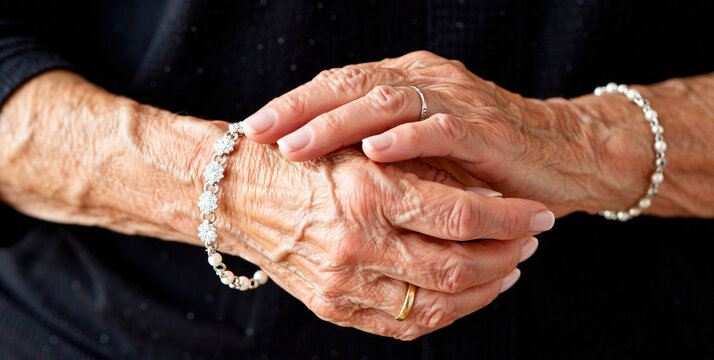 Elegant Hands Adorned with Delicate Jewelry in Soft Lighting