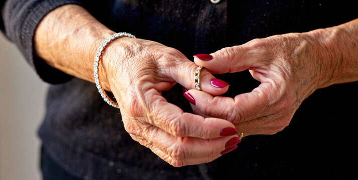 Hands of an Elderly Person Holding a Ring with Elegant Jewelry Accents