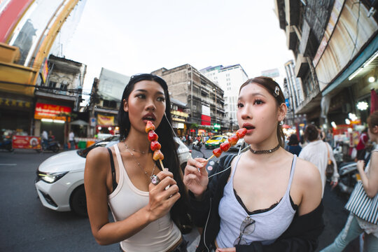 Authentic Gen Z asian young woman wide angle identity self street fashion standing at Chinatown street food