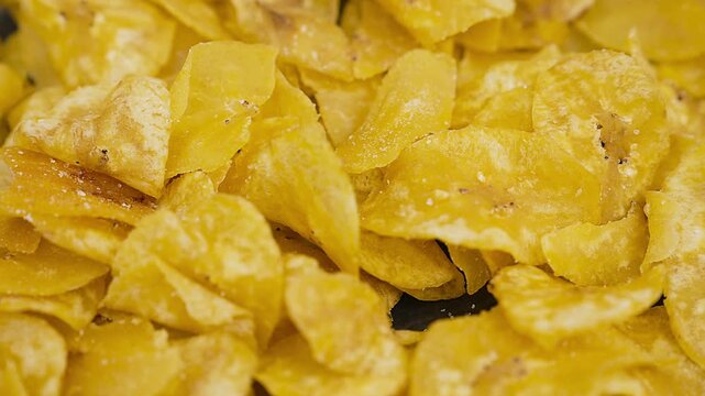 Crispy Peruvian chifles fried plantain chips in a bowl.