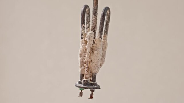 Failed Water Heater Heating Element Covered With Heavy Limescale Caused By Hard Water. Closeup Illustrating Appliance Failure, Replacement And Mineral Deposit Buildup.