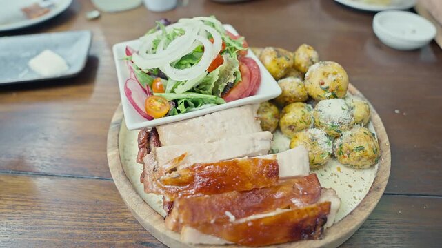 Peruvian roasted pork with crispy skin served with native potatoes 