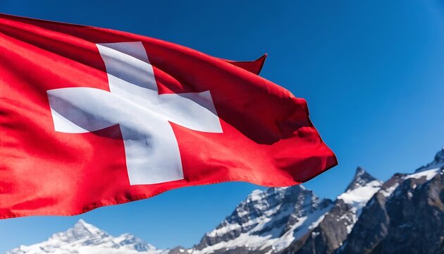 Close-up of swiss flag waving proudly against clear blue sky and high alpine mountain peaks with switzerland mountain national patriotism landscape outdoors vacation altitude heritage