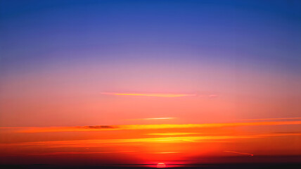 Fototapeta premium Vibrant Sunset Over Ocean Horizon with Dramatic Orange Sky, Scenic Evening Seascape Background Wallpaper
