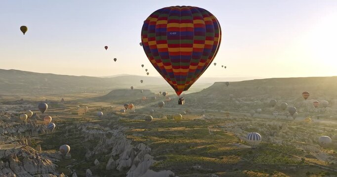 G�reme Turkey Aerial v64 remarkable landscape of world heritage site with unique rock formation, valley, plateau fields and hot air balloons in the sky at sunrise - Shot with Mavic 3 Cine - July 2022
