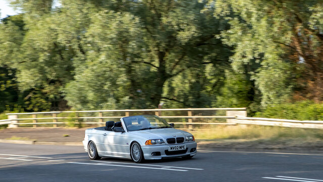 Milton Keynes,Bucks,UK - July 7th 2026: 2002 silver BMW 3 series 320 ci car driving on a British road