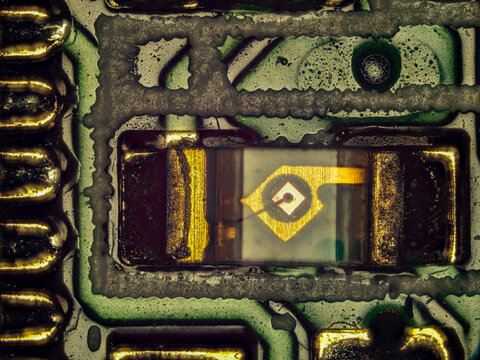 Microscope close-up of semiconductor electronic component on printed circuit board