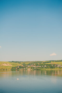 Peaceful river with green hills surround village
