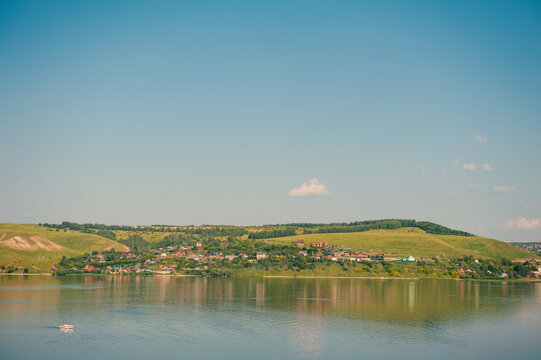 Peaceful river with green hills surround village